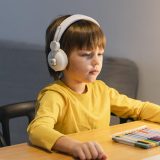 side-view-school-boy-yellow-shirt-taking-virtual-classes